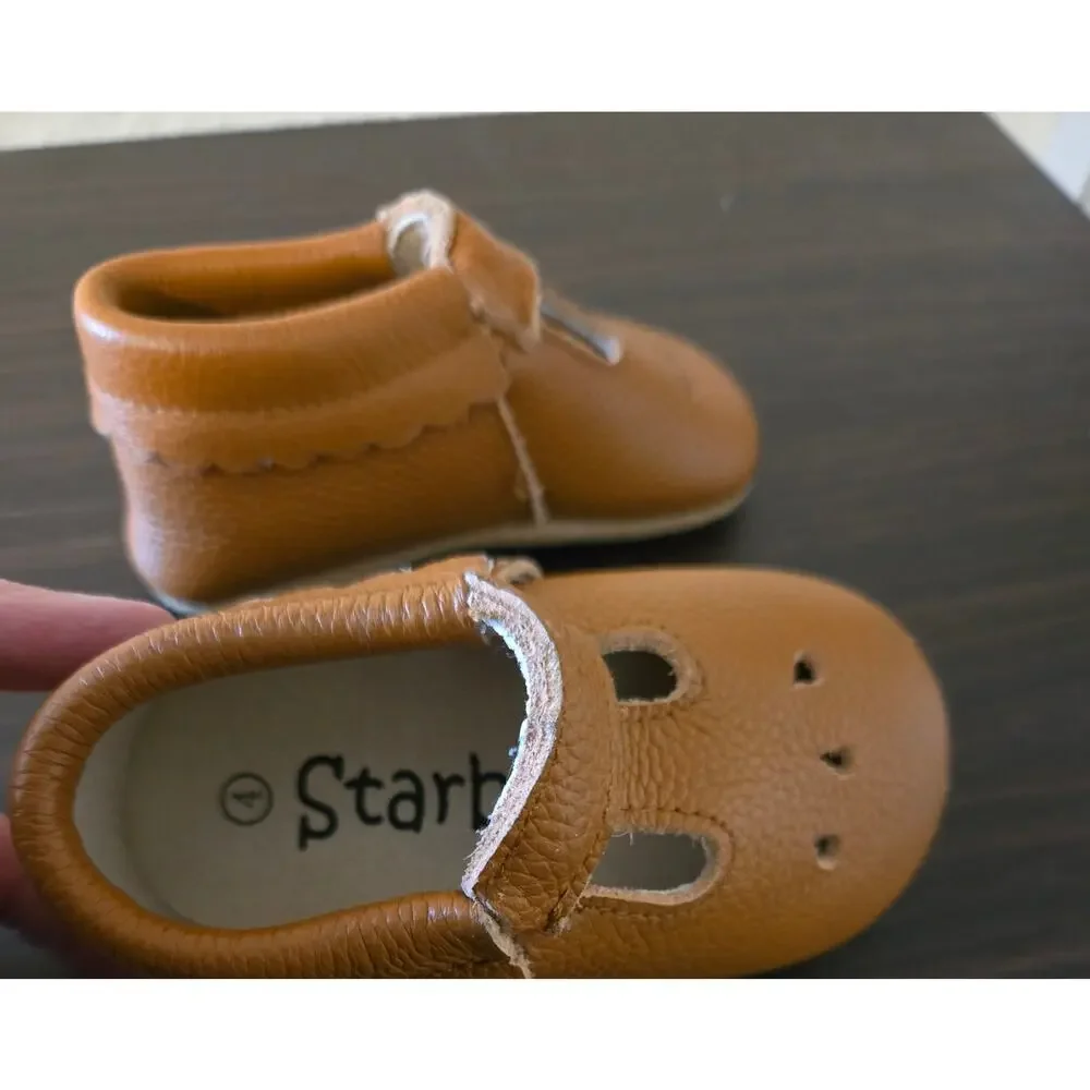 Brown leather Starbie baby moccasins with a T-strap design